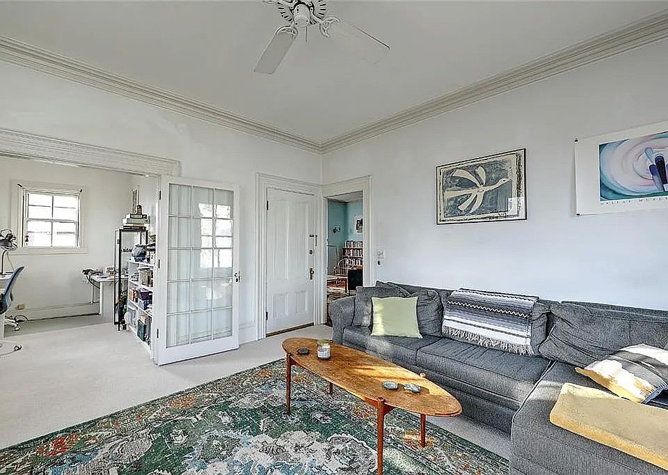 Main living room, furnished, before repainting, and with the old carpet that has been replaced for LVP wood floors