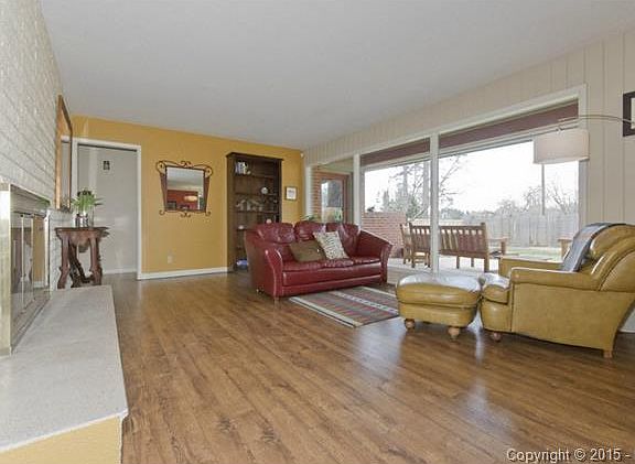 living room with a raised hearth gas burning fireplace and pictu