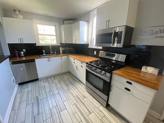 Newley remodeled kitchen with ceramic tile floors, new cabinets, butcher block countertops and stainless steel appliances.