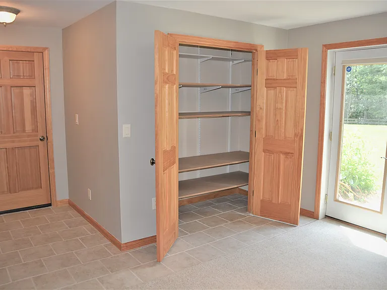 Large Storage Closet with hanging clothes rack added