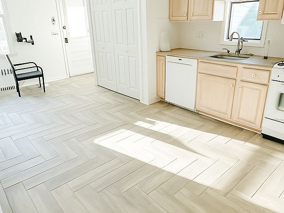 Open concept kitchen area includes a dishwasher