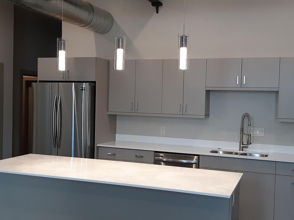 Stainless steel appliances- large island- quartz counter tops- custom made cabinets