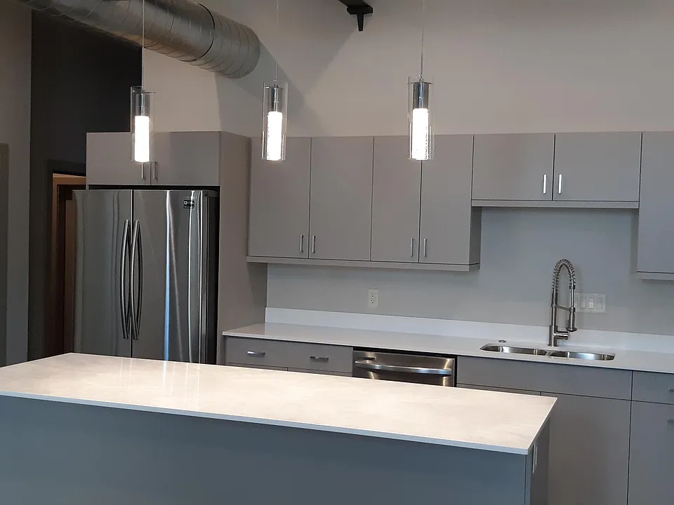 Stainless steel appliances- large island- quartz counter tops- custom made cabinets