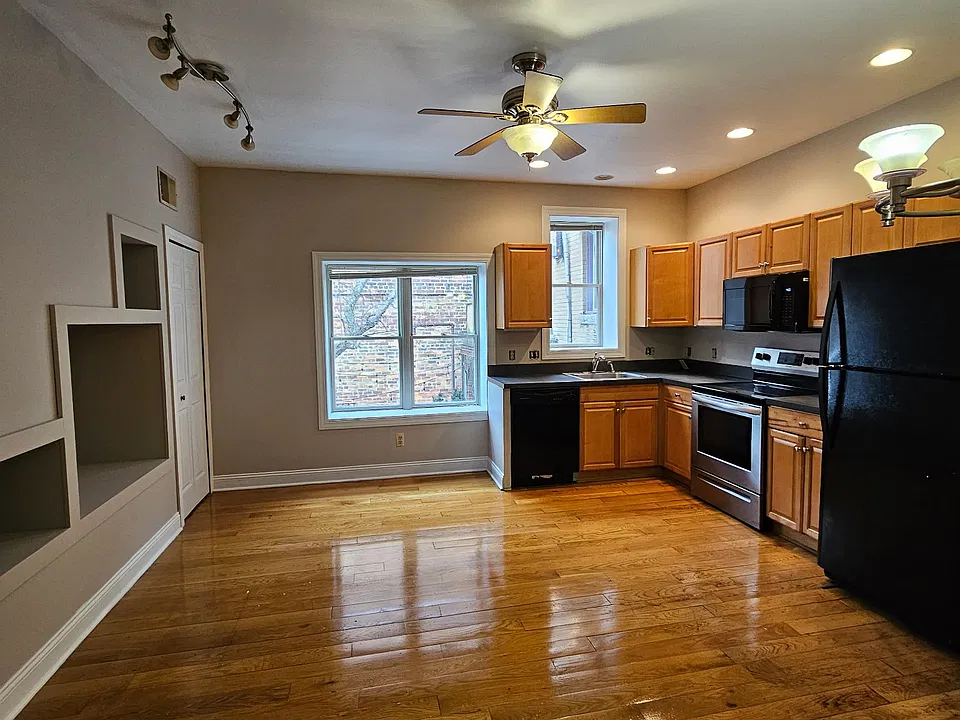 Beautiful hardwood floors with lots of cabinet space in the kitchen