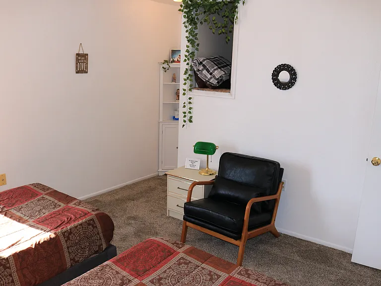 second bedroom has two single beds with memory foam, leather chair, cubby hole (for storage)