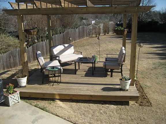 A custom pergola provides a place for relaxation - day or night