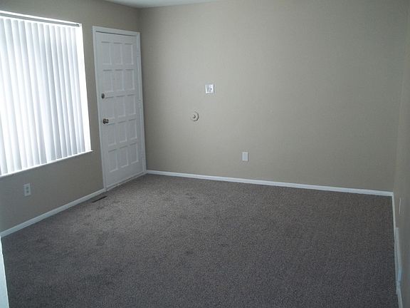 Inside front door, into living room. Solid wood front door, new paint, new carpeting and new vertical blinds.