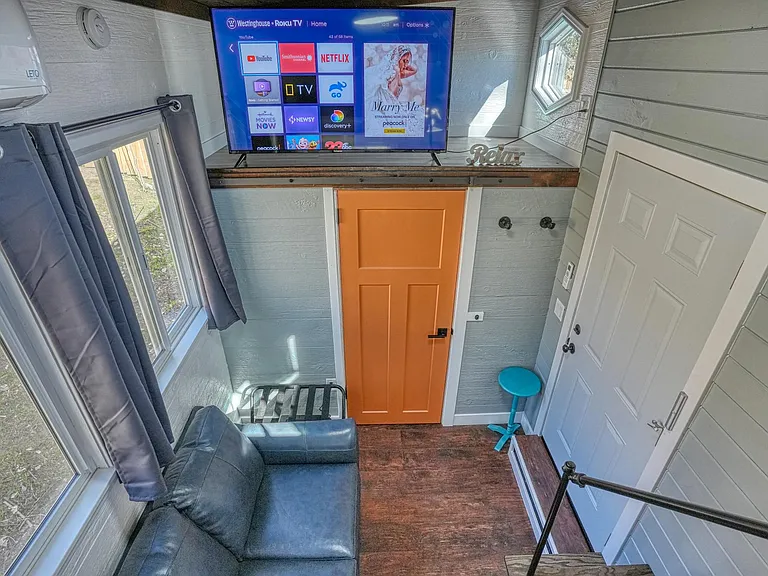 TV can be seen from all areas of tiny home and bed