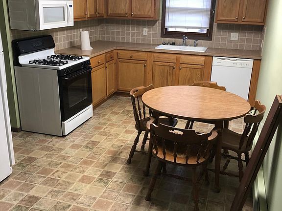 Kitchen with stove, fridge, dishwasher and microwave, also eating area