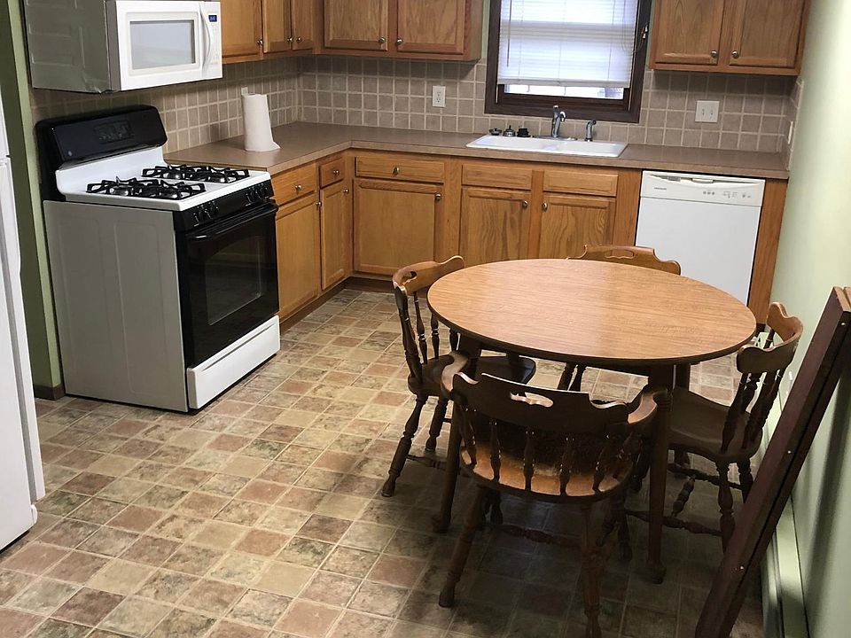 Kitchen with stove, fridge, dishwasher and microwave, also eating area