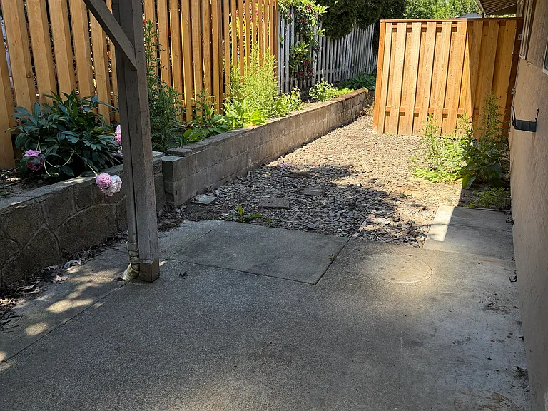 This outdoor space is ready for your touch. Garden, flower pots, furniture, all for you to make your own!