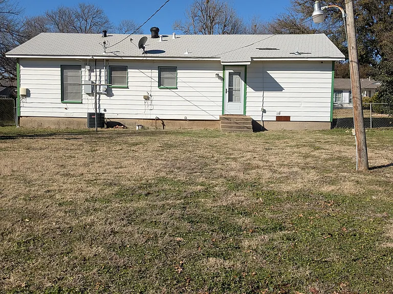 Back of house with large backyard