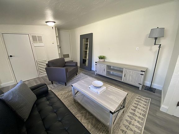 Living room: all new furniture, flooring, paint, lighting, and decor.