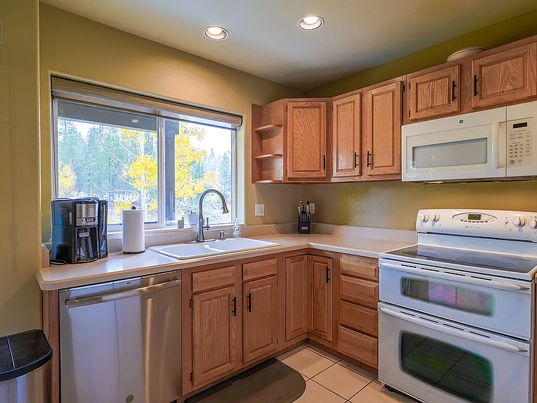 Kitchen with quiet dishwasher, coffee maker