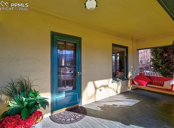 The beautiful front porch is warm and welcoming with plenty of space and a relaxing comfortable swing.