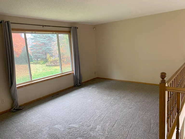 Living room with large picture window overlooking backyard. Fresh paint and brand new carpet throughout.