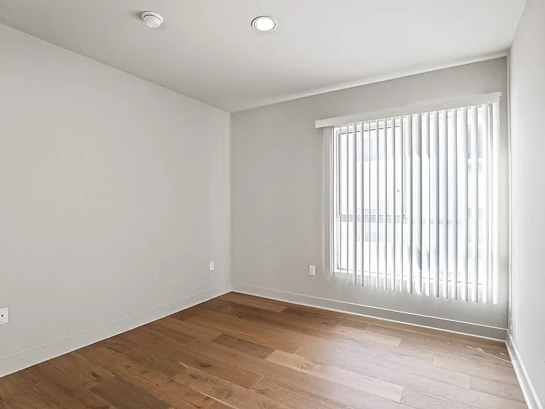 Bedroom with Large-Size Window and Vinyl Flooring