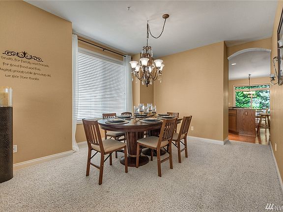 Dining Room with large window and curved pass through to kitchen - warm and inviting!