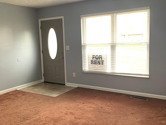 This is the entrance to the living room. All windows are newly installed. The front door has a new glass storm door as part of the entrance.
