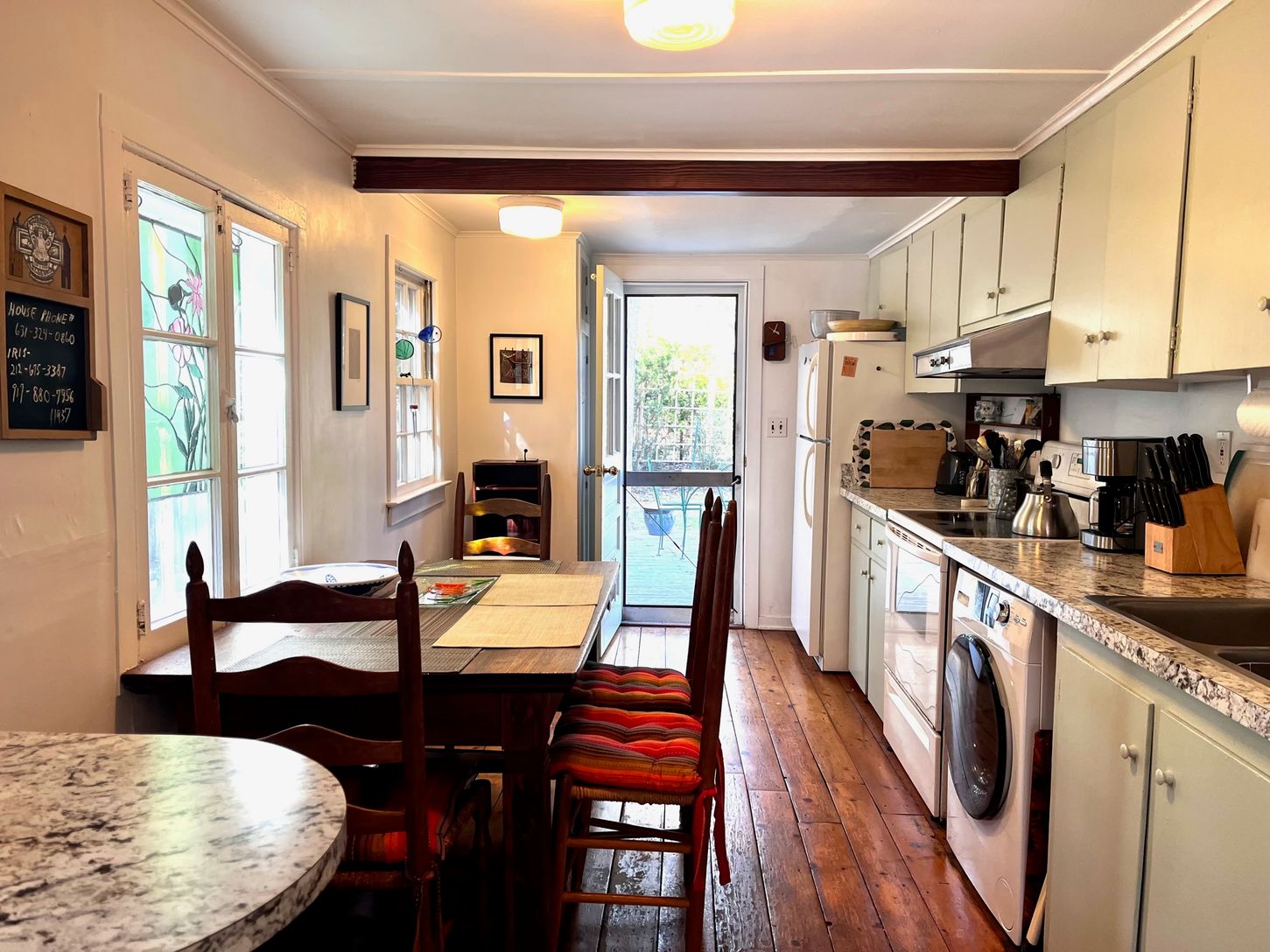 Kitchen looking towards the back part of cottage that extends to an outdoor deck area