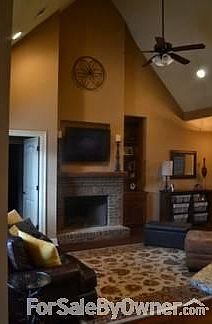 Great Room with Cathedral Ceilings
						:
						Open concept with built-in cabinetry, brick fireplace.