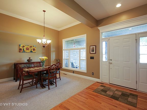 Entry is open to the formal dining room with beautiful view of the front yard.