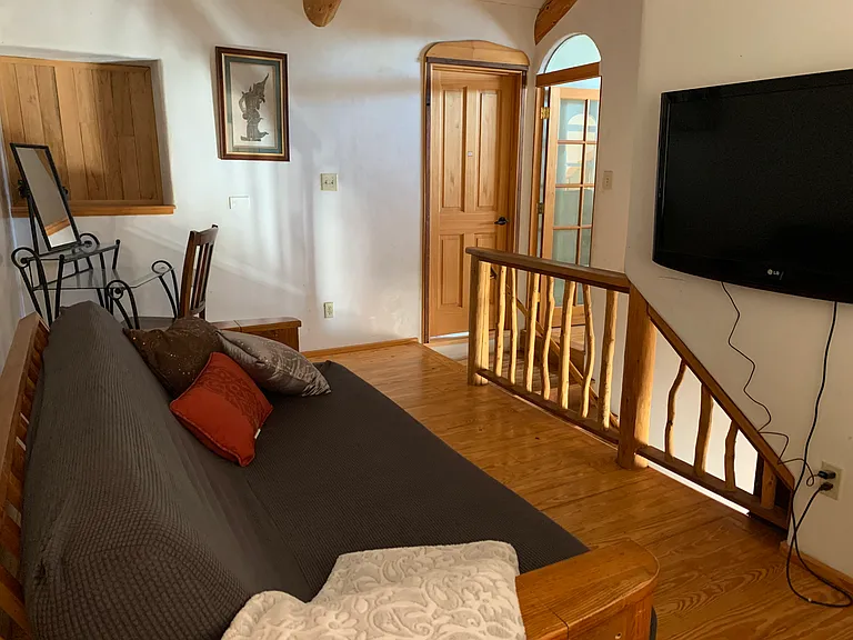 Upstairs loft - overlooking staircase and doors to main bedroom + skylight bedroom