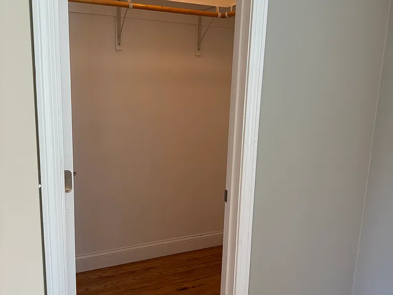 One of two matching walk-in closets in primary bedroom