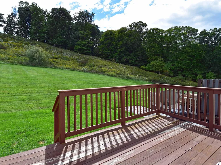 The deck opens into a flat backyard