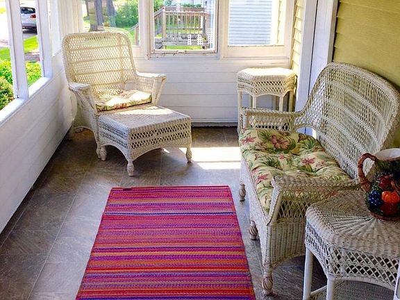Sunporch with shades and wicker furnishings available for te