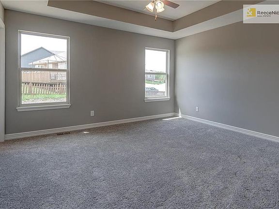 Large master suite with walk-in closet, tray ceiling, ceiling fan and spa-like bath.