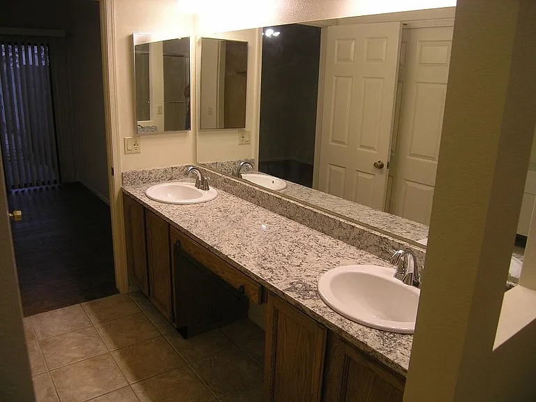 Master bathroom with double sinks and granite countertop