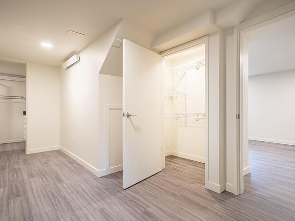 Bedroom with large closet with adjustable shelving/rods.