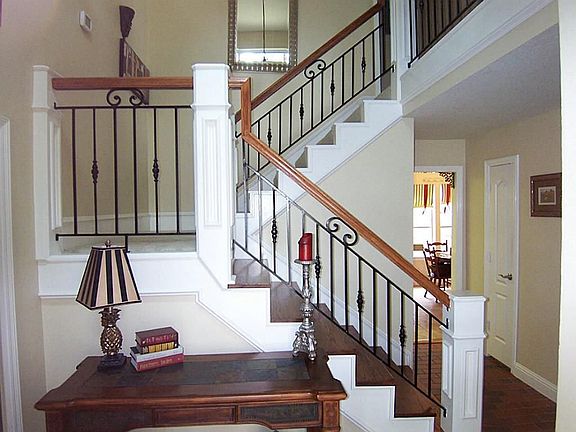 Gorgeous rod iron and wood railing grace the staircase.