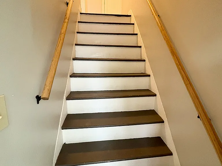 Stairs to 2 upstairs bedrooms and upstairs full bathroom
