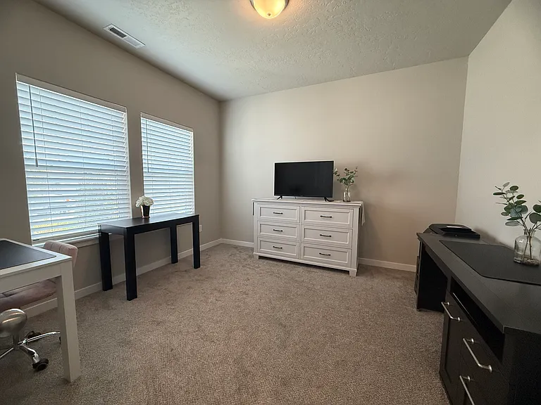 Flex room with two nice sized windows that open up to spacious front yard.
