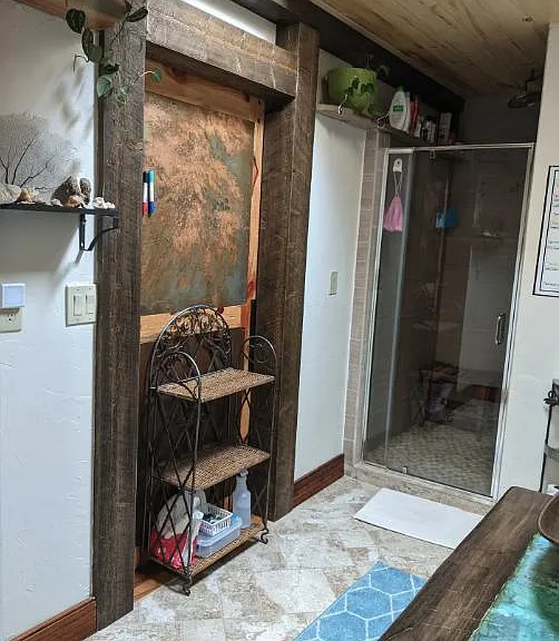 Upstairs shared bathroom with double sinks, walk-in shower