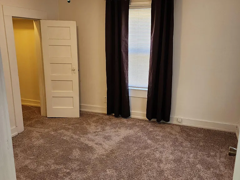 Main Bedroom. Small walk-in closet on left side of photo. 2 Windows. Both with blackout curtains and rods plus mini blinds. New Ceiling fan was added in summer which is not photographed.