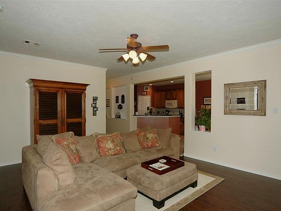  The other side of this great gathering space. Lighted ceiling fan and it opens to the kitchen.