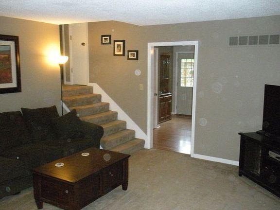 Living room with stairs leading to bedrooms