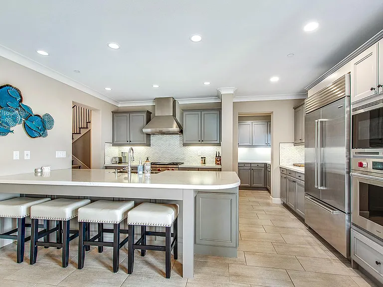 Open Gourmet kitchen with peninsula and bar seating