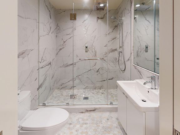 Bathroom with a toilet, sink and walk-in shower