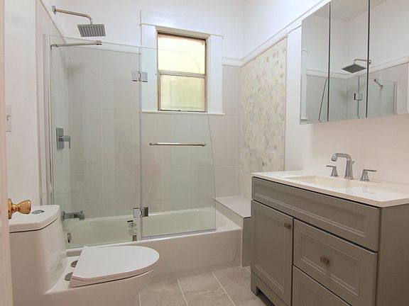 Brand new bathroom with shower over tub and window