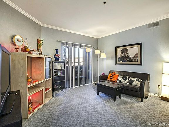 Light and bright family room with VIEWS from balcony. Fireplace located behind the cabinet.