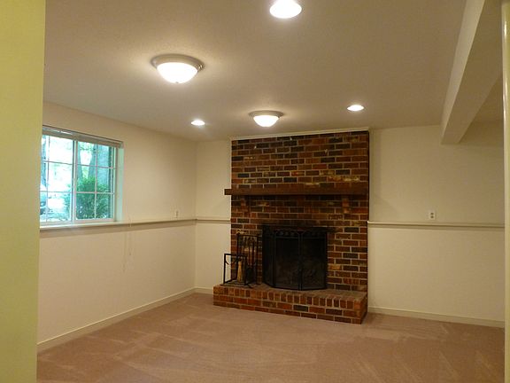 Den w/ wood burning fireplace