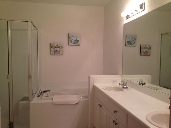 Master Bath with two sinks, walk in shower, comode and large