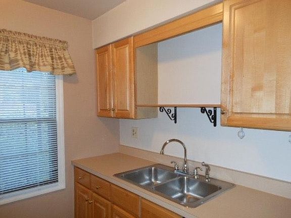 kitchen appliances include refrigerator,electric stove, dish
