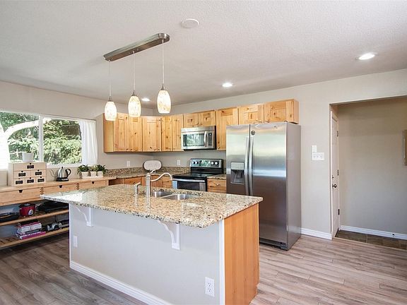 Updated kitchen with granite counters and center island...notice only one step to mudroom and garage!