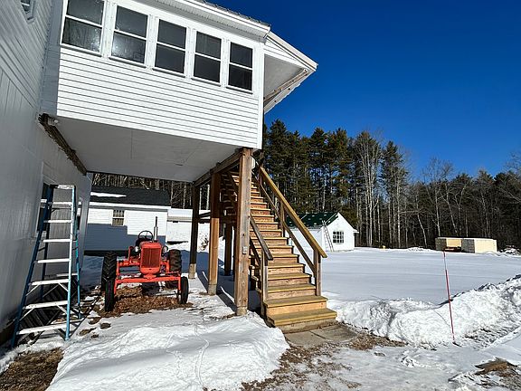 Staircase going to apartment and outside view of 3 season porch.