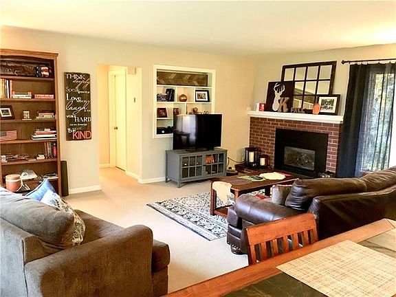 Large living room with gas fireplace and huge windows!